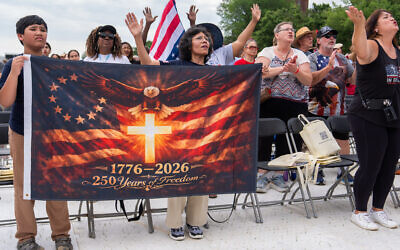 People worship to Christian music at Rededicate 250, a mostly conservative Christian prayer gathering in honor of the United States' 250th anniversary, on the National Mall in Washington, DC, Sunday, May 17, 2026. (AP/Julia Demaree Nikhinson)
