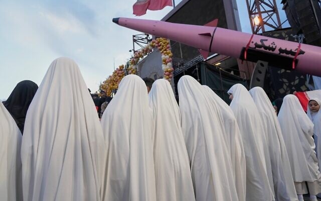 A group of girls stand beside a "Khaybar-buster" missile during a mass wedding ceremony for couples participating in the "Janfada" ("Sacrifice for Iran") pro-government campaign in Tehran, on May 18, 2026. (AP Photo/Vahid Salemi) A group of girls stand beside a "Khaybar-buster" missile during a mass wedding ceremony for couples participating in the "Janfada" ("Sacrifice for Iran") pro-government campaign in Tehran, on May 18, 2026. (AP Photo/Vahid Salemi)