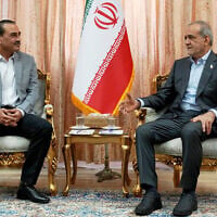In this photo released by the Iranian Presidency Office, President Masoud Pezeshkian, right, speaks with Pakistan's Army Chief Field Marshal Gen. Asim Munir in Tehran, Iran, on May 23, 2026. (Iranian Presidency Office via AP)