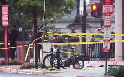 Evidence markers are seen on a crime scene after police responded to reports of shots fired near the White House, May 23, 2026, in Washington. (AP Photo/Alex Brandon)