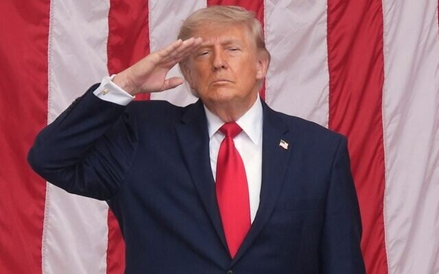 US President Donald Trump salutes during the playing of 'Taps' at the 158th National Memorial Day Observance coinciding with the nation's 250th anniversary, at the Memorial Amphitheater in Arlington National Cemetery, May 25, 2026, in Arlington, Virginia. (AP Photo/ Alex Brandon)