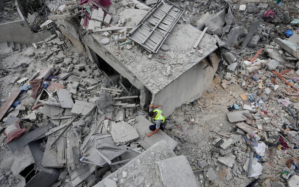 A rescue worker searches through the rubble of buildings destroyed in an Israeli airstrike a day earlier in the southern village of Charnay, Lebanon, May 27, 2026. (AP Photo/Mohammed Zaatari)
