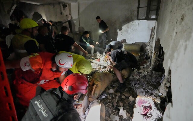 Rescue workers search for victims inside a destroyed apartment that was damaged by an Israeli airstrike in the southern port city of Sidon, Lebanon, May 28, 2026. (AP Photo/Mohammed Zaatari)