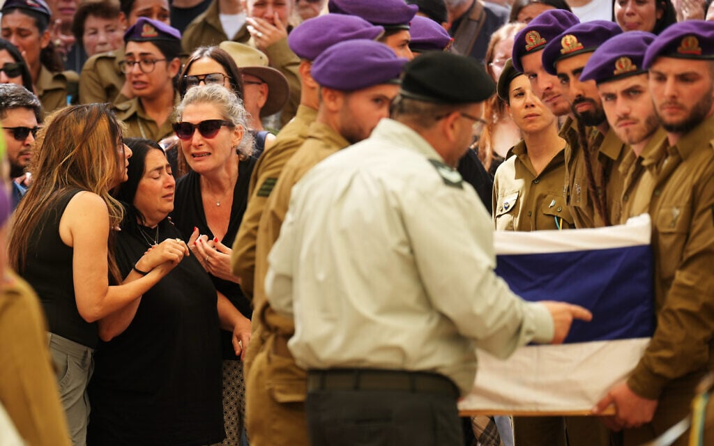Hilit Yanai, second from left, mother of Israeli soldier Sgt. Rotem Yanai, who was killed in a Hezbollah drone attack in northern Israel, is comforted by relatives during the funeral of her daughter in Givat Ada, May 28, 2026. (AP Photo/Ariel Schalit)