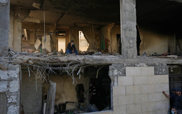 A man speaks on his phone inside a destroyed apartment that was hit in an Israeli airstrike in Shuwayfat, just south of Beirut, Lebanon, May 28, 2026. (AP Photo/Hussein Malla)