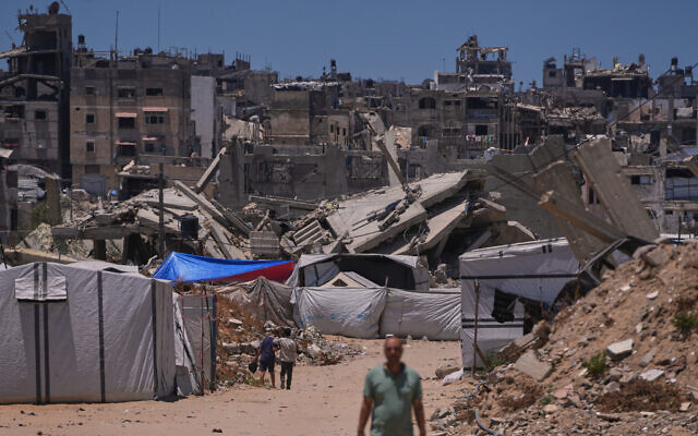 Palestinians walk along a street surrounded by buildings destroyed by Israeli military strikes during the Israel-Hamas war in Khan Younis, southern Gaza Strip, May 29, 2026. (AP Photo/Abdel Kareem Hana) Palestinians walk along a street surrounded by buildings destroyed by Israeli military strikes during the Israel-Hamas war in Khan Younis, southern Gaza Strip, May 29, 2026. (AP Photo/Abdel Kareem Hana)