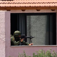 An Israeli solider takes a position in a house in the community of Metula, northern Israel, on the border with Lebanon, May 31, 2026. (AP Photo/Ariel Schalit)