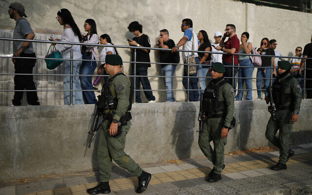 Soldiers patrol as voters arrive at a polling station during the presidential election in Barranquilla, Colombia, May 31, 2026. (AP Photo/Ivan Valencia)