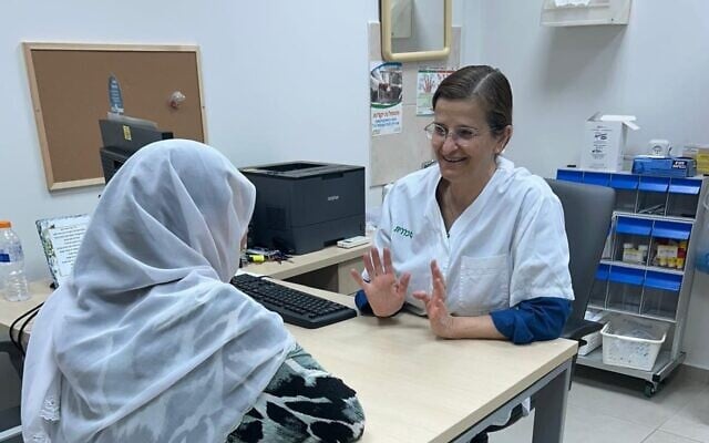 Dr. Nadia Khir, right, the first female Druze doctor in Israel, consults with a Druze woman in the Clalit health clinic in Julis, Western Galilee, on May 22, 2026. (Courtesy)