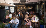 Israelis sit at a restaurant in Tel Aviv, April 4, 2021. (Miriam Alster/FLASH90)
