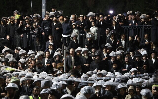 People gather to watch the lighting on the central bonfire during Lag B'Omer celebrations on Mount Meron, northern Israel, on May 4, 2026. (David Cohen/Flash90)