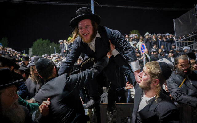 Ultra-Orthodox Jewish man hops a crowd control barrier at Mount Meron during Lag B'Omer celebrations on May 4, 2026. (David Cohen/Flash90) Ultra-Orthodox Jewish man hops a crowd control barrier at Mount Meron during Lag B'Omer celebrations on May 4, 2026. (David Cohen/Flash90)