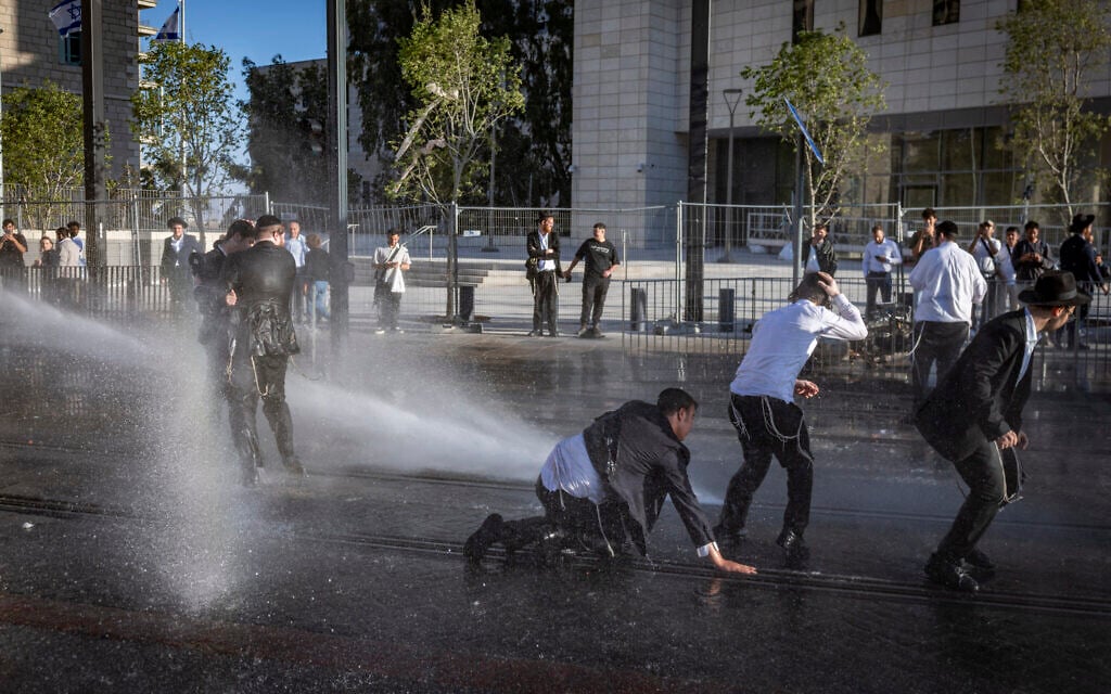 Ultra-Orthodox Jewish men clash with police in Jerusalem during a protest against the jailing of seminary students who failed to comply with military enlistment orders, May 7, 2026. (Chaim Goldberg/Flash90)