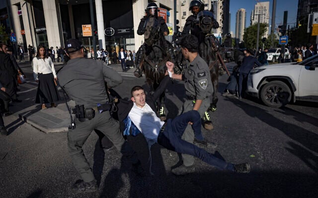 Ultra-Orthodox Jewish men clash with police in Jerusalem during a protest against the jailing of seminary students who failed to comply with military enlistment orders, May 7, 2026. (Chaim Goldberg/Flash90)