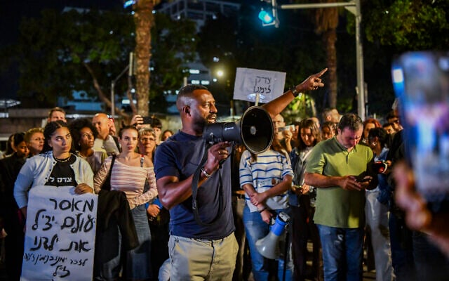Protesters gather on May 9, 2026, outside the State Attorney's Office in Tel Aviv, holding signs and calling for justice following the killing of Yemanu Binyamin Zelka, a Pizza Hut employee who was stabbed and later died of his wounds on Independence Day (Avshalom Sassoni/Flash90)