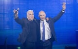 Opposition Leader Yair Lapid, left, and former prime minister Naftali Bennett embrace during a rally of their joint party Together in Tel Aviv on May 12, 2026. (Miriam Alster/Flash90)