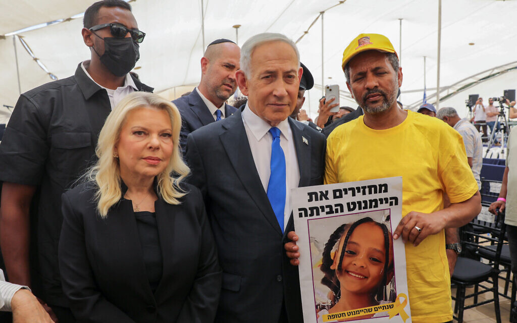 Prime Minister Benjamin Netanyahu and his wife, Sara, seen with the family members of missing girl Haymanut Kasau at a ceremony at Mount Herzl, for Ethiopian Jews who died while making their way to Israel, May 14, 2026. (Gil Yohanan/POOL)