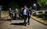 Ultra-Orthodox Jewish men protest against the jailing of yeshiva students who evaded the draft outside the home of Military Police chief Brig. Gen. Yuval Yamin in Ashkelon, May 14, 2026. (Tsafrir Abayov/Flash90)