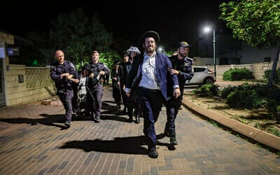 Ultra-Orthodox Jewish men protest against the jailing of yeshiva students who evaded the draft outside the home of Military Police chief Brig. Gen. Yuval Yamin in Ashkelon, May 14, 2026. (Tsafrir Abayov/Flash90)