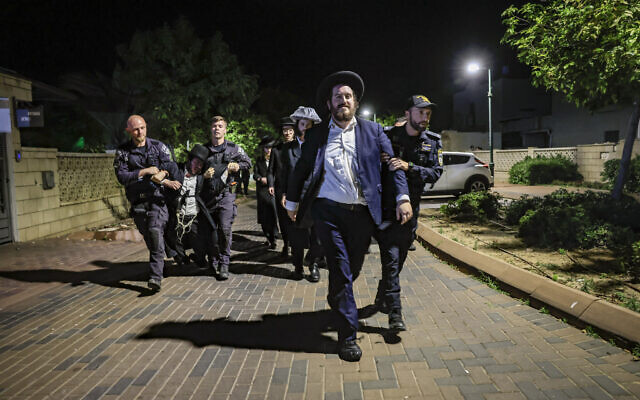 Ultra-Orthodox Jewish men protest against the jailing of yeshiva students who evaded the draft outside the home of Military Police chief Brig. Gen. Yuval Yamin in Ashkelon, May 14, 2026. (Tsafrir Abayov/Flash90) Ultra-Orthodox Jewish men protest against the jailing of yeshiva students who evaded the draft outside the home of Military Police chief Brig. Gen. Yuval Yamin in Ashkelon, May 14, 2026. (Tsafrir Abayov/Flash90)