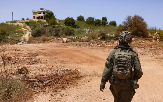 An Israeli soldier walks through a village in southern Lebanon during an Israeli military operation, May 17, 2026. (David Cohen/Flash90)