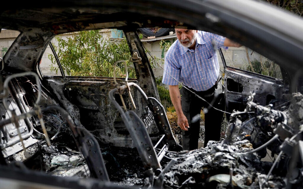 A Palestinian man inspects damage to a vehicle allegedly destroyed by Jewish settlers from the nearby Bat Ein settlement, in the village of Surif, West Bank on May 17, 2026 (Wisam Hashlamoun/FLASH90) A Palestinian man inspects damage to a vehicle allegedly destroyed by Jewish settlers from the nearby Bat Ein settlement, in the village of Surif, West Bank on May 17, 2026 (Wisam Hashlamoun/FLASH90)