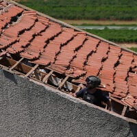 Israeli security forces are seen at a home in Metula, near the Israel-Lebanon border, that was hit by a Hezbollah unmanned aerial vehicle on May 25, 2026. (Ayal Margolin/Flash90)