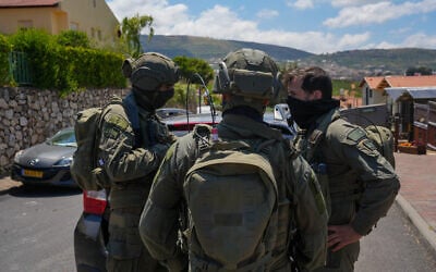 Israeli security forces are seen outside a home in Metula, near the Israel-Lebanon border, that was hit by a Hezbollah unmanned aerial vehicle on May 25, 2026. (Ayal Margolin/Flash90)