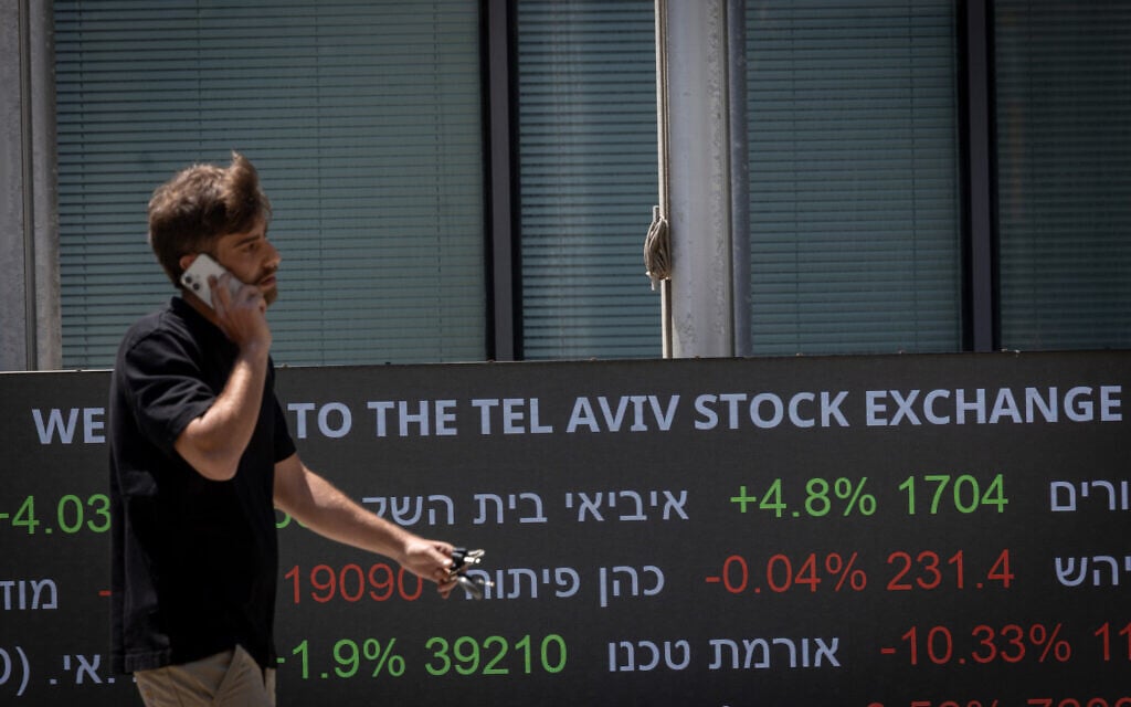 A man walks past the The Tel Aviv stock exchange, May 25, 2026. (Miriam Alster/FLASH90)