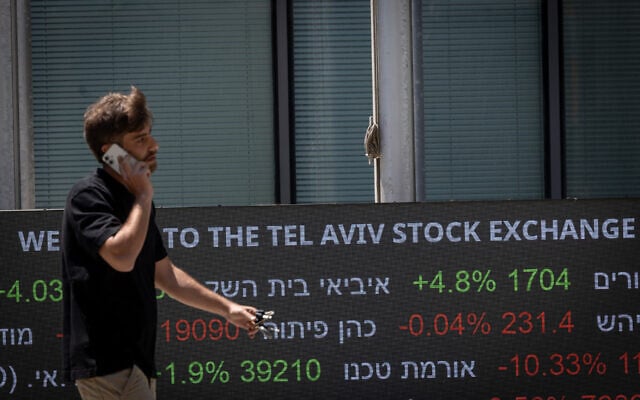 A man walks past the The Tel Aviv stock exchange, May 25, 2026. (Miriam Alster/FLASH90)