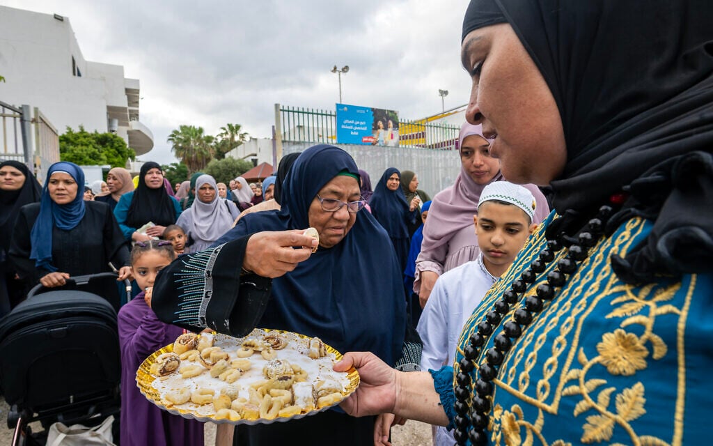 People gather for early morning prayers on a football field to mark the holiday of Eid al-Adha, in Jisr az-Zarqa, northern Israel, May 27, 2026. (Yael Abas Gusiky/Flash90)