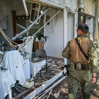 A member of the security forces surveys the scene where a Hezbollah rocket hit the northern city of Kiryat Shmona, May 30, 2026. (Michael Giladi/Flash90)