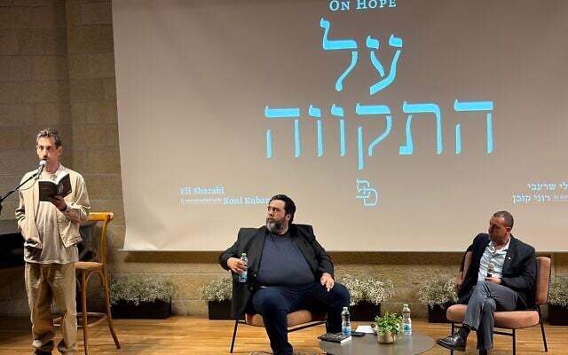 Eli Sharabi (R) and Roni Kuban (center) during a reading of Sharabi's book 'Hostage' at the International Writers Festival in Jerusalem on May 28, 2026. (Jessica Steinberg/The Times of Israel)