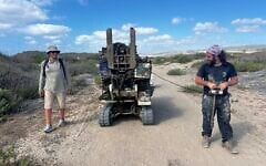 Gilad Shtienberg, left, and another researcher take the geotube to the right spot in the former Kebara wetland of the Carmel coast, northern Israel. (Courtesy, Tom Levy)