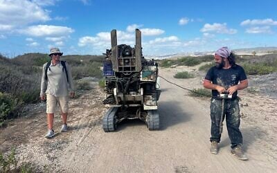 Gilad Shtienberg, left, and another researcher take the geotube to the right spot in the former Kebara wetland of the Carmel coast, northern Israel. (Courtesy, Tom Levy) Gilad Shtienberg, left, and another researcher take the geotube to the right spot in the former Kebara wetland of the Carmel coast, northern Israel. (Courtesy, Tom Levy)