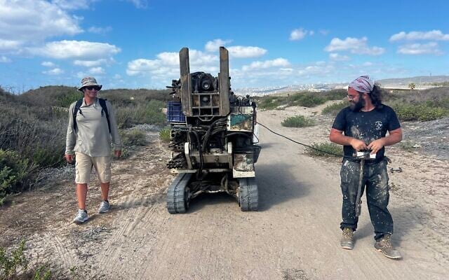 Gilad Shtienberg, left, and another researcher take the geotube to the right spot in the former Kebara wetland of the Carmel coast, northern Israel. (Courtesy, Tom Levy)