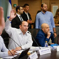 Chairman Simcha Rothman and coalition members of the Knesset Constitution, Law and Justice Committee vote to advance a bill splitting the position of the attorney general, May 19, 2026. (Noam Moskowitz/Office of the Knesset Spokesperson)