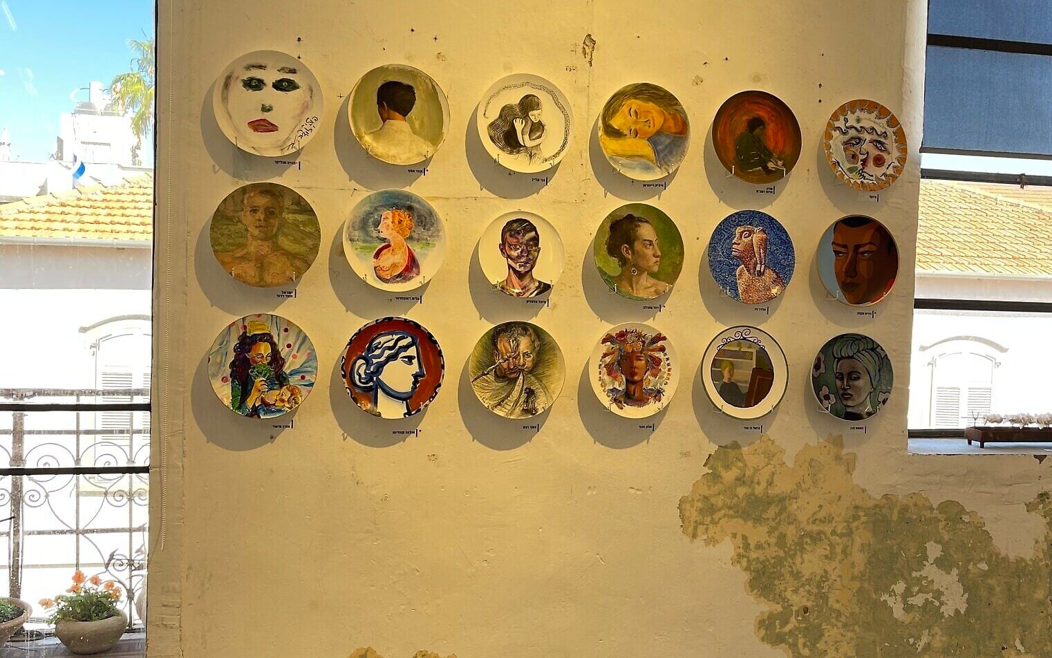 Artists paint dinner plates for lone soldier charity