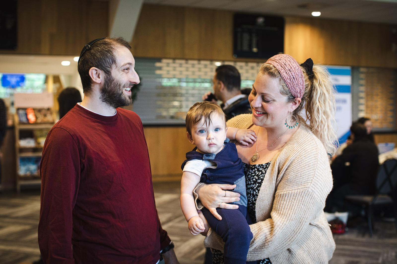 Hezzie Raymond and Tamara Sireling Raymond, along with their 9-month-old son, attend the Aliyah Day fair at StoneX Stadium in north London, May 10, 2026. (Omri Dagan for the Jewish Agency for Israel) Hezzie Raymond and Tamara Sireling Raymond, along with their 9-month-old son, attend the Aliyah Day fair at StoneX Stadium in north London, May 10, 2026. (Omri Dagan for the Jewish Agency for Israel)