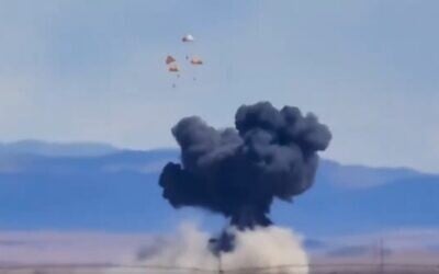 Four pilots parachute toward the ground as a plume of smoke rises above a plain near Mountain Home Air Force Base, Idaho, where two US Navy jets collided at an air show on May 17, 2026. (Screenshot: X/Shane Ogden)