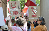 Demonstrators holding signs as they gather near the Francis Scott Key Bridge during a rally in support of the Iranian people and to condemn the execution of political prisoners in Iran, in Washington, DC, on May 16, 2026. (Amid Farahi/ AFP)