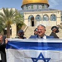 A handout photo of National Security Minister Itamar Ben Gvir displaying an Israeli flag atop the Temple Mount alongside Otzma Yehudit MK Yitzhak Kroizer during Jerusalem Day, May 14, 2026. (Otzma Yehudit)