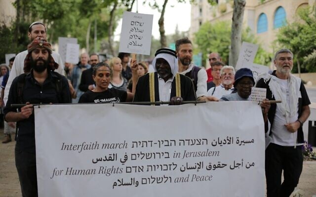Coexistence activists led by Jewish, Muslim, Christian, and Druze religious leaders march in Jerusalem for 'human rights and peace,' on May 18, 2026. (Jacob Lazarus/ Rabbis for Human Rights)