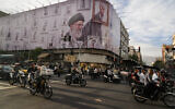 Motorbikes driving past a billboard showing the slain Iranian supreme leader Ali Khamenei, in downtown Tehran, Iran, May 6, 2026. (AP Photo/Vahid Salemi, File)