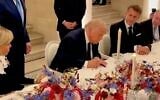 A screenshot of video released by the White House shows US President Donald Trump signing the Persian-language version of the memorandum of understanding with Iran, at the Palace of Versailles in France, June 17, 2026. (X screenshot)