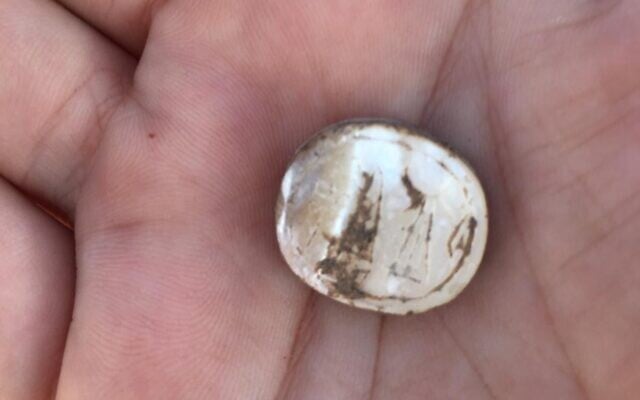 Ido Koch holds a 2,600-year-old seal found at Tel Hadid in 2019 (Courtesy/Ido Koch)