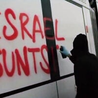 A pro-Palestinian, anti-Israel activist sprays the phrase "destroy Israel" in the Basque language on the side of a light rail carriage manufactured by CAF for the Tel Aviv light rail's Purple Line, in Beasain, Spain, in a video from June 4, 2026. (Screenshot/X, used in accordance with Clause 27a of the Copyright Law)