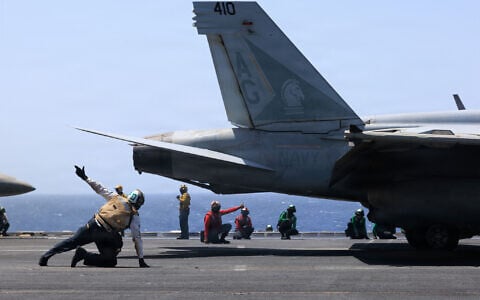 US Sailors signal an F/A-18E Super Hornet, attached to Strike Fighter Squadron (VFA) 105, aboard Nimitz-class aircraft carrier USS George H.W. Bush (CVN 77), in a photo published June 5, 2026. (US Navy photo)