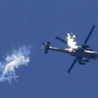 An Israeli Apache helicopter fires an anti-missile flare over Rafah in the southern Gaza Strip, during a military operation on June 25, 2006, (SAMUEL ARANDA / AFP)