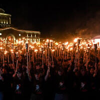 Armenians take part in the annual torch march on the eve of the Genocide Remembrance Day in Yerevan, on April 23, 2025. (KAREN MINASYAN / AFP)